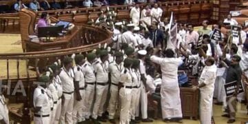 Opposition MLAs protest in the Well of the Kerala Legislative Assembly holding placards over the Sabarimala gold theft probe.