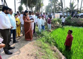 District Collector Chadalavada Nagarani interacting with farmers during e-crop booking field inspection at Bhairavapalem, Narasapuram Mandal.