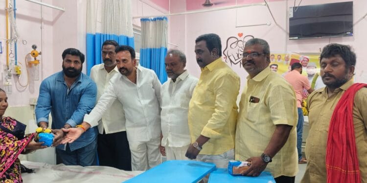 Sukhavasi Srinivas distributing fruits to new mothers at Guntur Government General Hospital during Mohammed Naseer birthday celebrations.