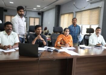 ASR District Collector A.S. Dinesh Kumar reviewing resurvey and mutation applications with revenue officials.