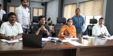 ASR District Collector A.S. Dinesh Kumar reviewing resurvey and mutation applications with revenue officials.