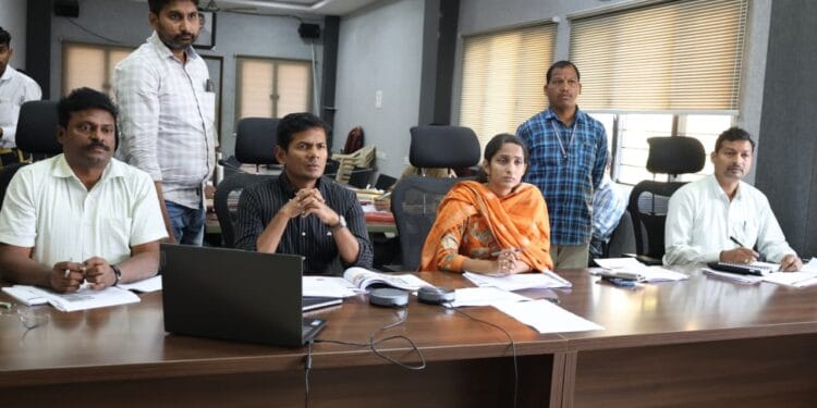 ASR District Collector A.S. Dinesh Kumar reviewing resurvey and mutation applications with revenue officials.