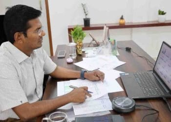 ASR District Collector Dinesh Kumar reviewing PGRS and Revenue Clinic petitions with officials through a video conference.