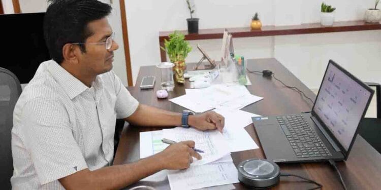 ASR District Collector Dinesh Kumar reviewing PGRS and Revenue Clinic petitions with officials through a video conference.