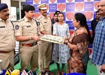 Eluru SP Pratap Shiva Kishore handing over recovered cyber fraud money to victim in Eluru