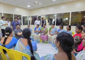 Gudivada MLA Venigandla Ramu interacting with Anganwadi workers during a meeting at Praja Vedika office in Gudivada