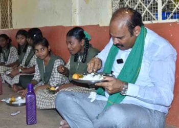 Minister Parthasarathi dining with students during mid-day meal inspection in Eluru