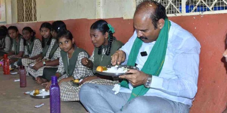 Minister Parthasarathi dining with students during mid-day meal inspection in Eluru