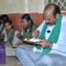 Minister Parthasarathi dining with students during mid-day meal inspection in Eluru