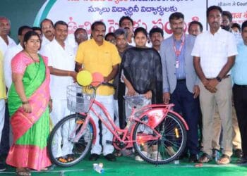 Minister Nimmala Ramanaidu distributing bicycles to students in Palakollu