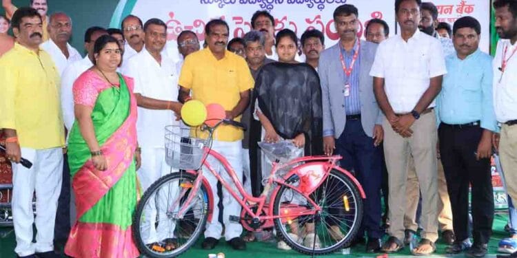 Minister Nimmala Ramanaidu distributing bicycles to students in Palakollu