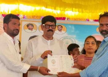 Minister Anam Ramanarayana Reddy distributing new Pattadar Passbooks with government seal and QR code to farmers in Yanamadala village of Chejerla mandal.