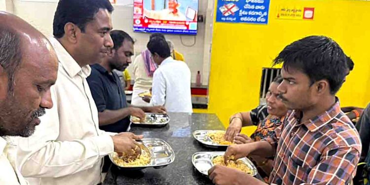 NTR District Collector Lakshmeesha giving laptop to engineering student